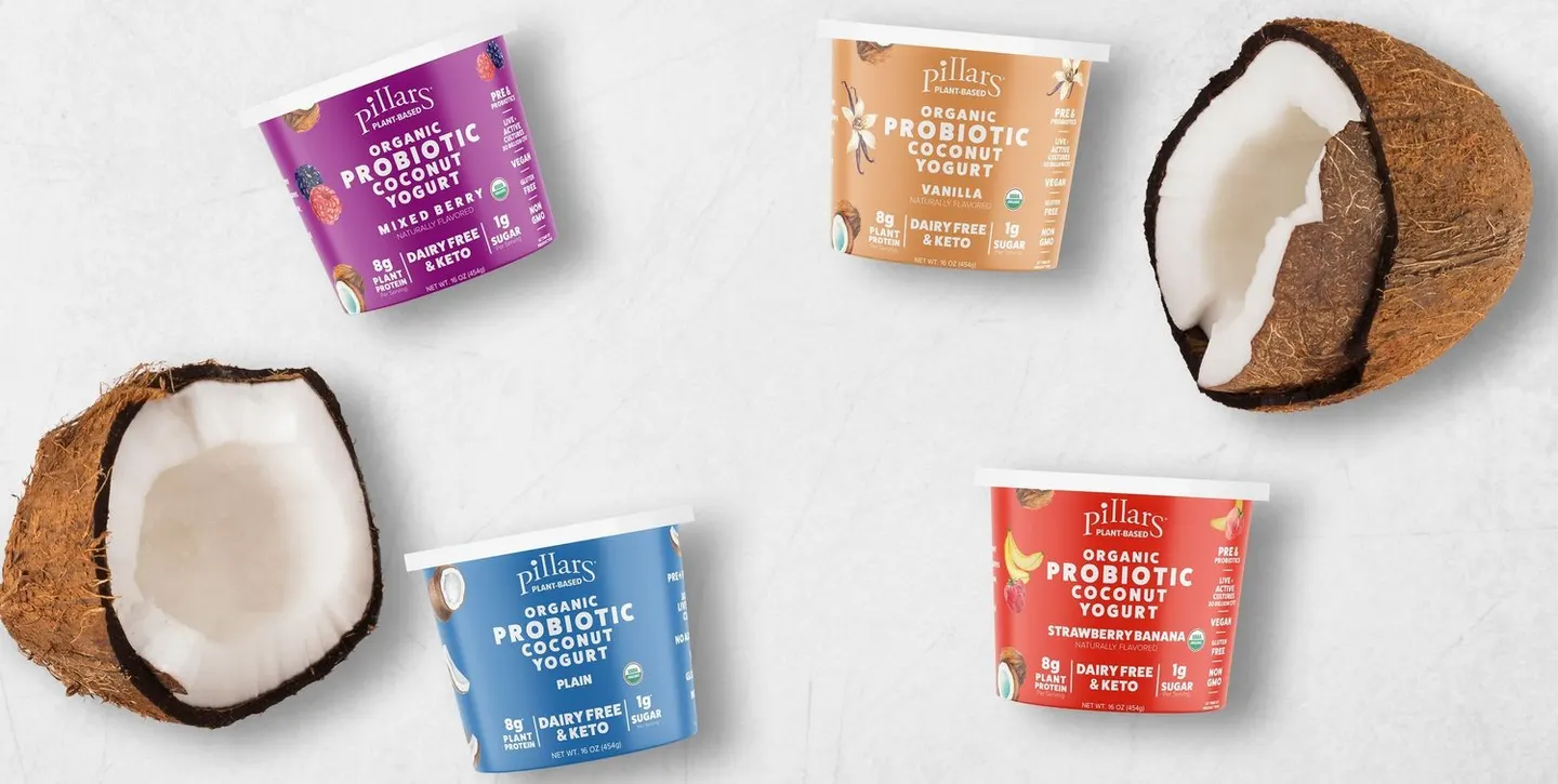 Pillars plant-based yogurt cups arranged with coconut halves